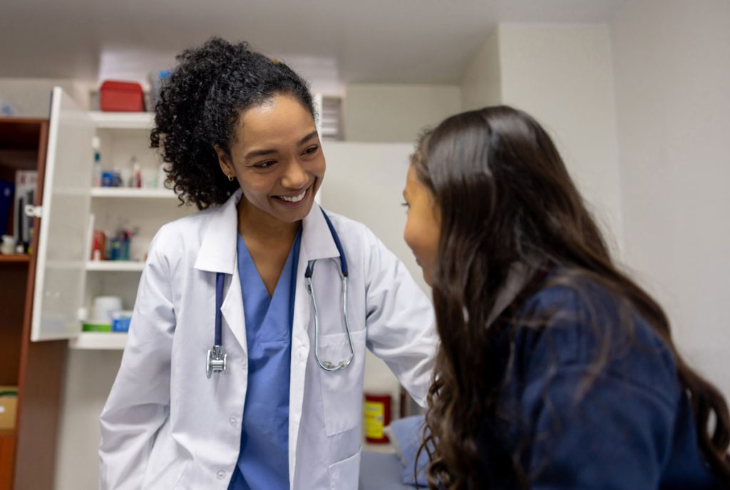 school nurse helping student during checkup