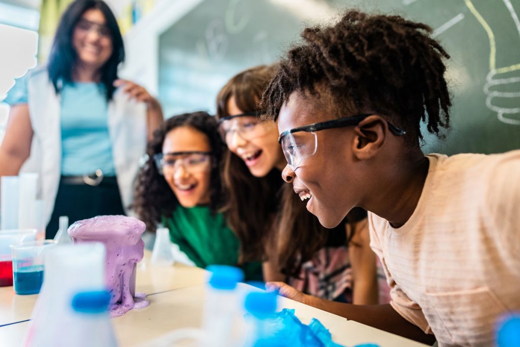 group of students being led by teacher during science experiment