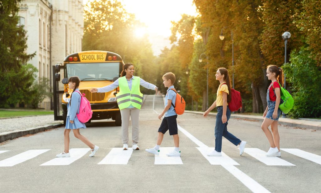 crossing guard helping students cross the road